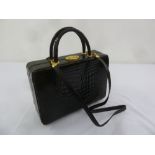 An Asprey ladies black crocodile handbag/vanity case with shoulder strap