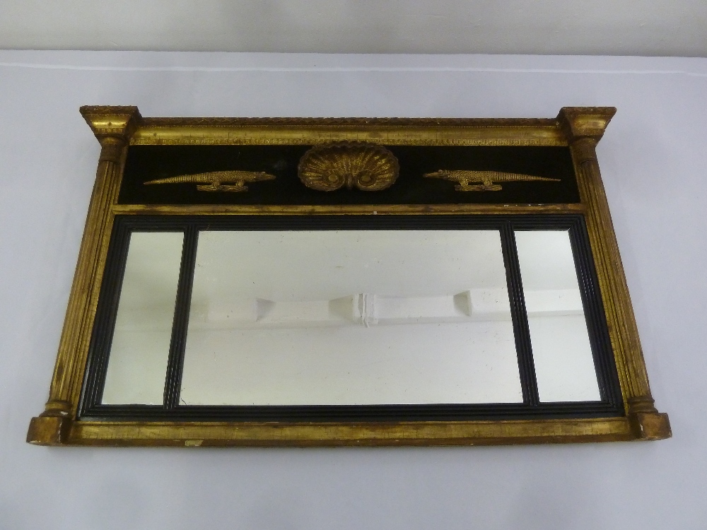 A Regency rectangular gilded wall mirror with fluted columnular sides surmounted by applied carved