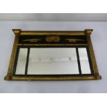 A Regency rectangular gilded wall mirror with fluted columnular sides surmounted by applied carved