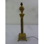 A gilt metal and onyx table lamp of Corinthian form on raised square base