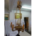 A French Empire gilt metal seven light chandelier, the central light formed as a stylised flame