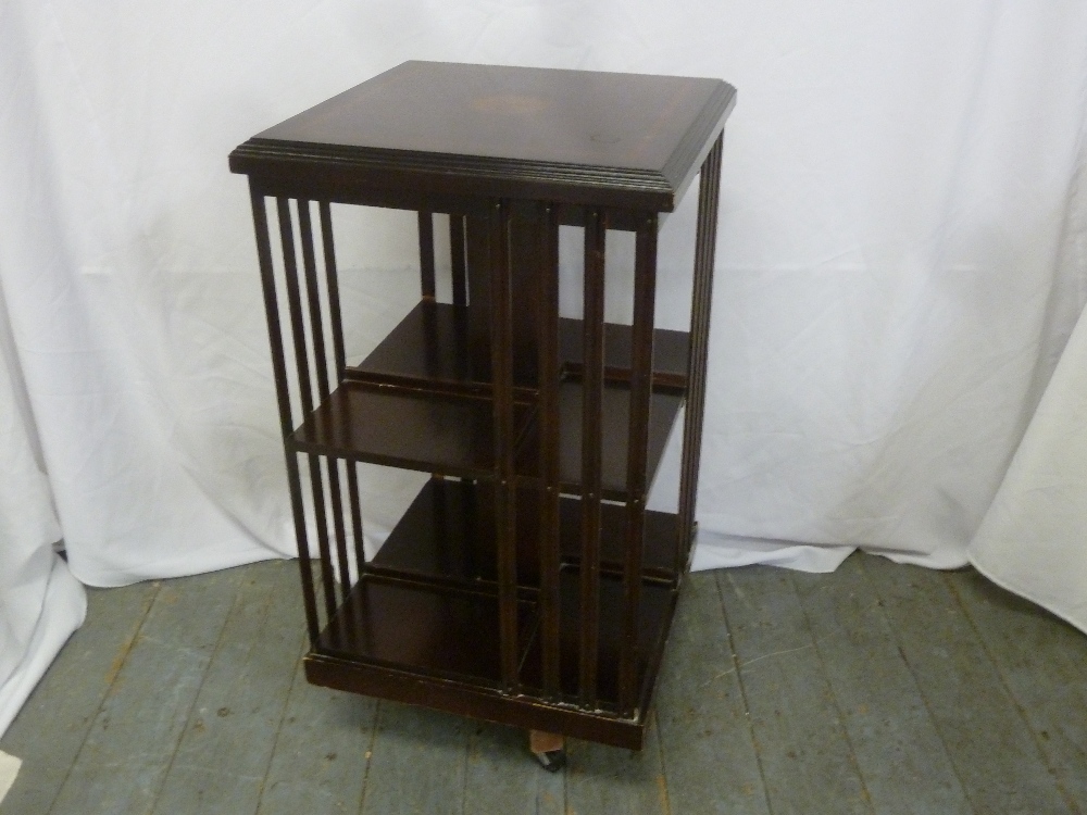 A mahogany revolving Canterbury with slatted sides on original casters, A/F