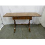 A mahogany rectangular occasional table with hinged side flaps on scroll supports with original