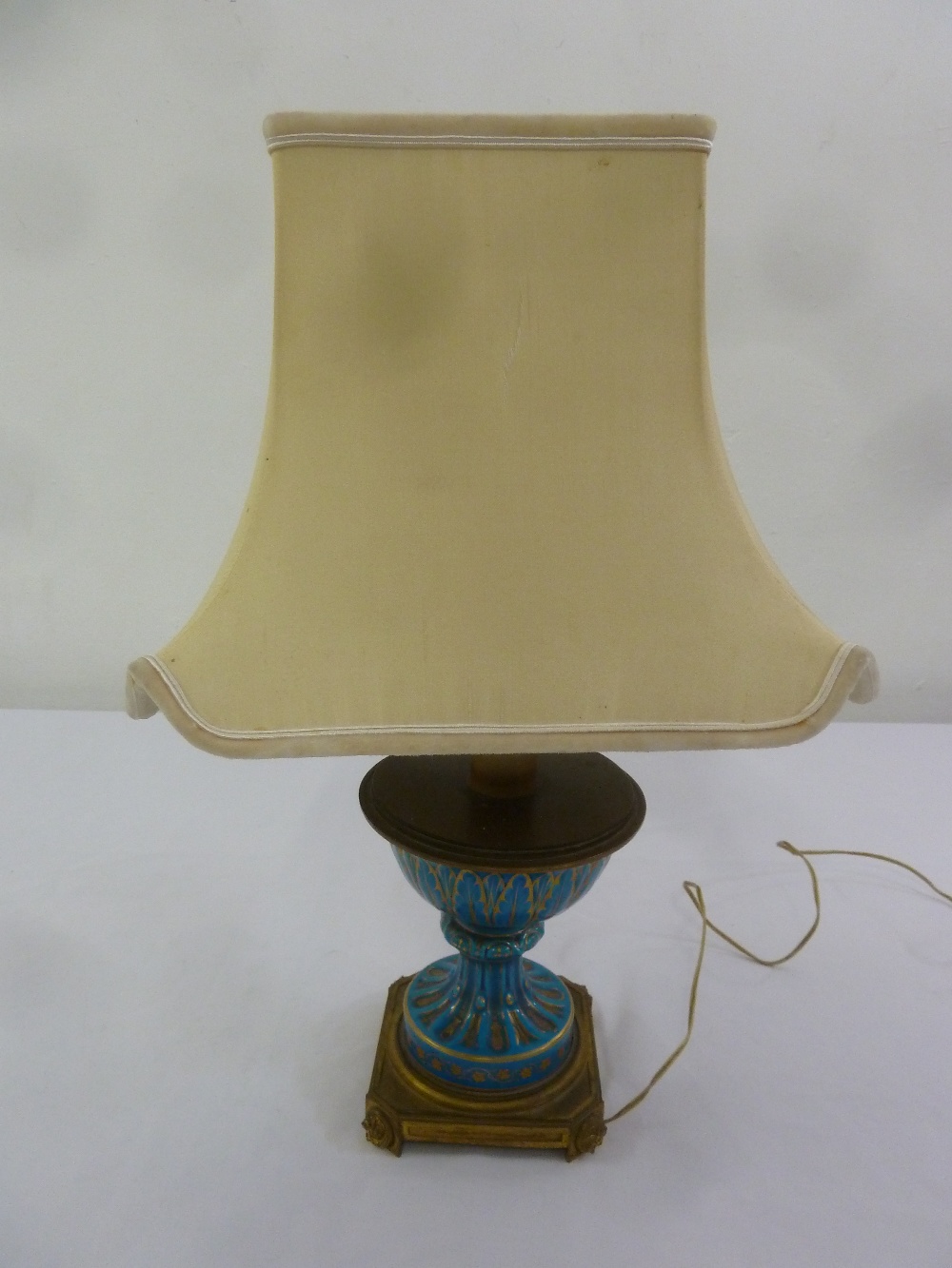 A Continental decorative ceramic table lamp on square ormolu plinth with silk shade