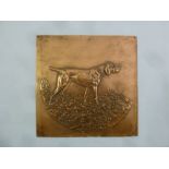 A rectangular copper plaque embossed with a hunting dog, signed bottom right