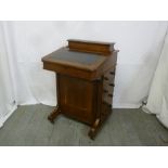A late 19th century mahogany Davenport of customary form with tooled leather top