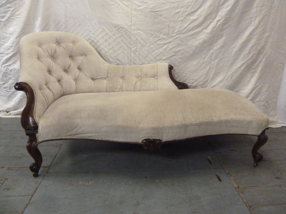 A Victorian mahogany chaise longue with scroll upholstered button back on four scroll legs
