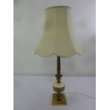 A brass and porcelain decorative table lamp on raised square base to include silk shade