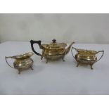 A three piece silver teaset, rounded rectangular on scroll legs, Sheffield 1919