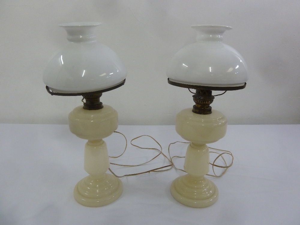 A pair of Victorian glass oil lamps with glass shades later converted to electricity, A/F