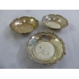 Three circular panelled bonbon dishes with scroll borders