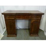 A Victorian rectangular mahogany pedestal knee hole desk with three drawers and cupboards