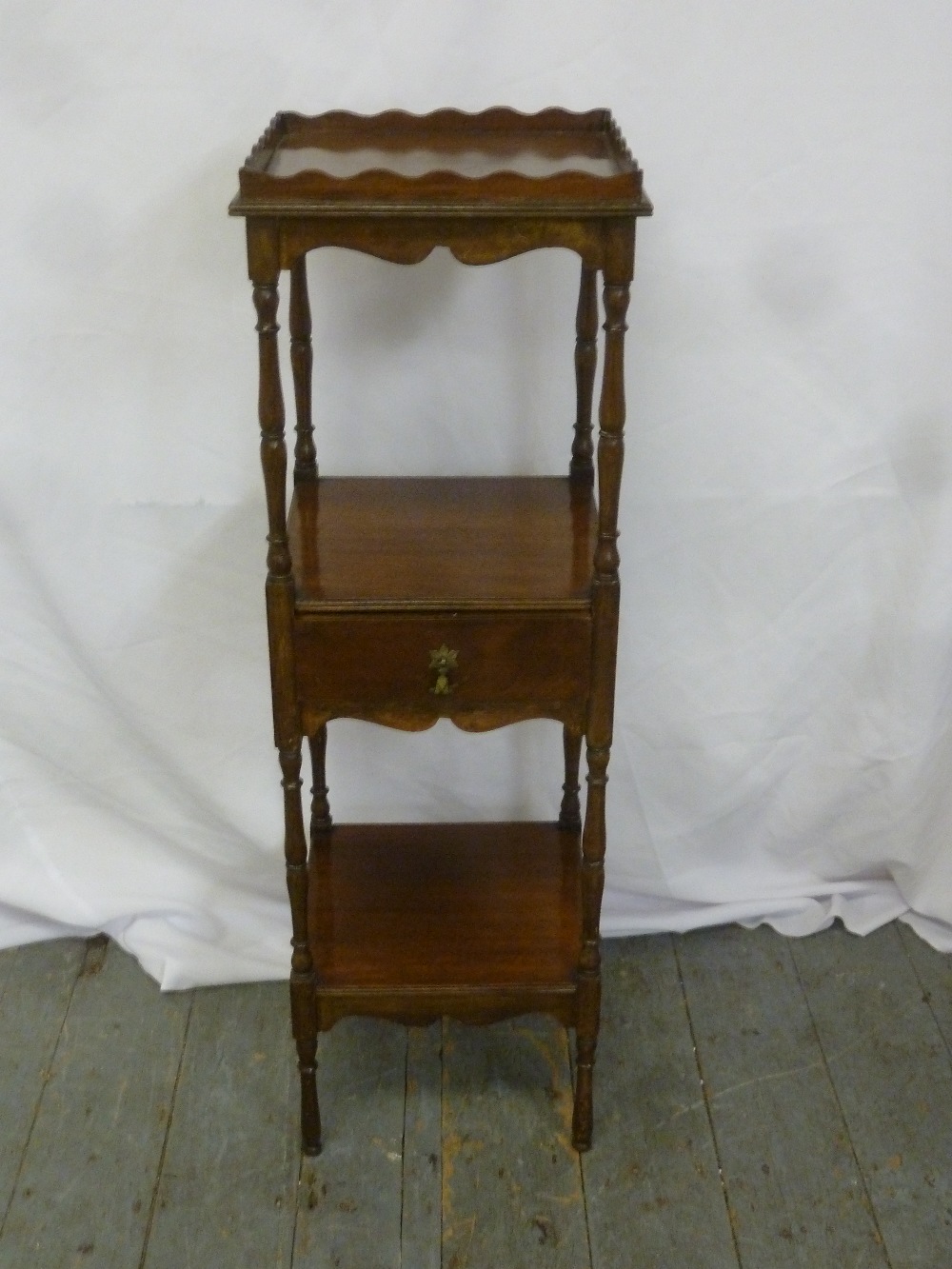 A three tier rectangular mahogany whatnot on turned legs