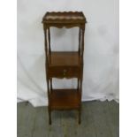 A three tier rectangular mahogany whatnot on turned legs