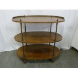 An oval three tier mahogany whatnot with brass gallery and supports