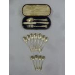 A cased silver Christening set and eleven silver teaspoons