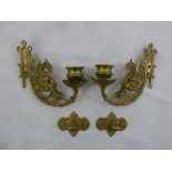 A pair of brass wall sconces with cast mythological figures and brackets