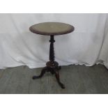 A Victorian mahogany circular wine table with tooled leather top with twist stem on tripod base