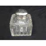 A square cut glass inkwell with silver mount and domed hinged cover