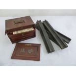 A mid 20th century Chinese Mah-jong set in fitted wooden case with four slides
