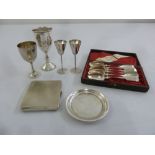 A quantity of silver to include a Kiddush cup, a card tray, a cigarette case and white metal spoons