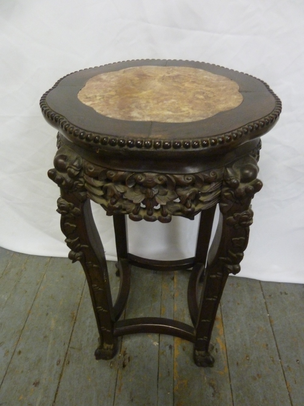 A Chinese hardwood plant stand with inset marble top