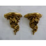 A pair of gilded wooden wall sconces in the baroque style