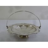 Mappin and Webb circular silver fruit stand, lobed with applied scroll border and swing handle on