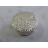 A Dutch silver circular pill box, chased with figures in a forest, import marked for London 1905