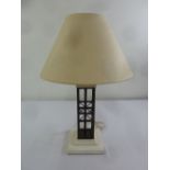 A modern ceramic and base metal table lamp and shade