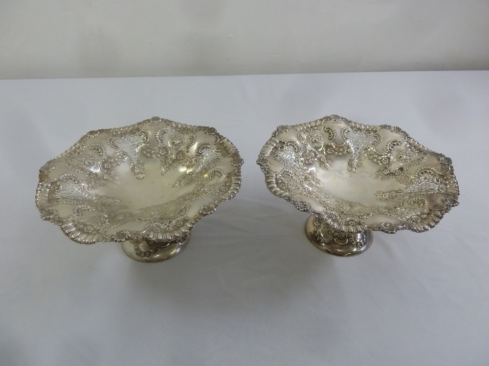 A pair of Mappin and Webb silver fruit stands, shaped circular, pierced and chased with flowers,