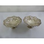 A pair of Mappin and Webb silver fruit stands, shaped circular, pierced and chased with flowers,
