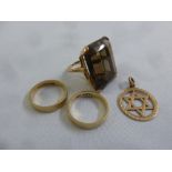 9ct gold ring set with a smokey topaz, two 9ct wedding bands and a 9ct gold Star of David pendant,