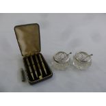 A cased set of silver bridge pencils and a pair of glass salts with silver mounts and condiment