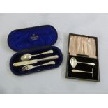 A cased silver Christening set comprising knife, fork and spoon and a cased silver childs pusher and
