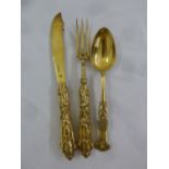 A Victorian silver gilt Christening set comprising knife, fork and spoon, profusely chased with