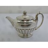 A George III silver coffee pot of circular lobed form the hinged cover with bud finial on raised