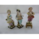 A pair of porcelain Continental figurines and a Meissen figurine of a boy on a gilt metal stand