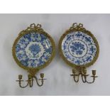 A pair of Continental 19th century ormolu, blue and white ceramic girandoles supporting three branch