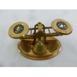 A set of brass postal scales set with pietra dura plaques and a full set of weights
