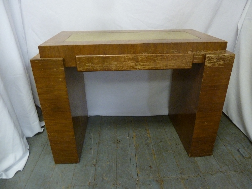 An Art Deco rectangular blonde oak veneered desk with tooled leather top and flanked by bookshelves