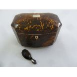 An early 19th century tortoiseshell tea caddy of elongated octagonal form the hinged cover revealing