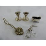 A quantity of silver and white metal to include a pair of dwarf candle sticks, a pair of ribbon
