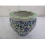 A Chinese ceramic fish bowl plant holder decorated with stylised leaves and flowers