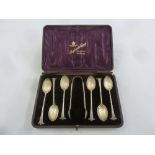 A cased set of silver teaspoons and a pair of matching tongs