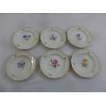 Six Meissen dessert plates circa 1920 decorated with flowers and gilded scroll and shell borders,
