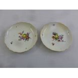 A pair of Meissen Mid 19th century dishes decorated with flowers and fruit with gilded borders,