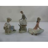 Three Lladro figurines of children in various poses