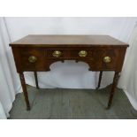 A Regency rectangular mahogany sideboard with brass handles on four turned cylindrical legs