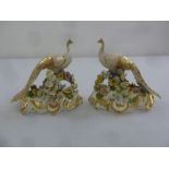 A pair of early 19th century Derby gold peacocks on bocage floral bases, A/F